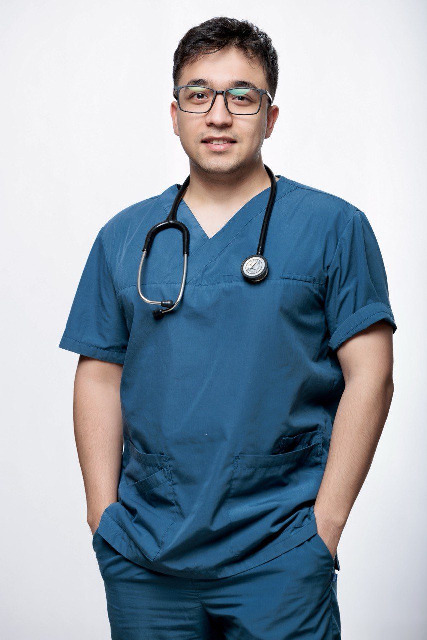 Portrait of Asadbek Sultonov in scrubs with a stethoscope